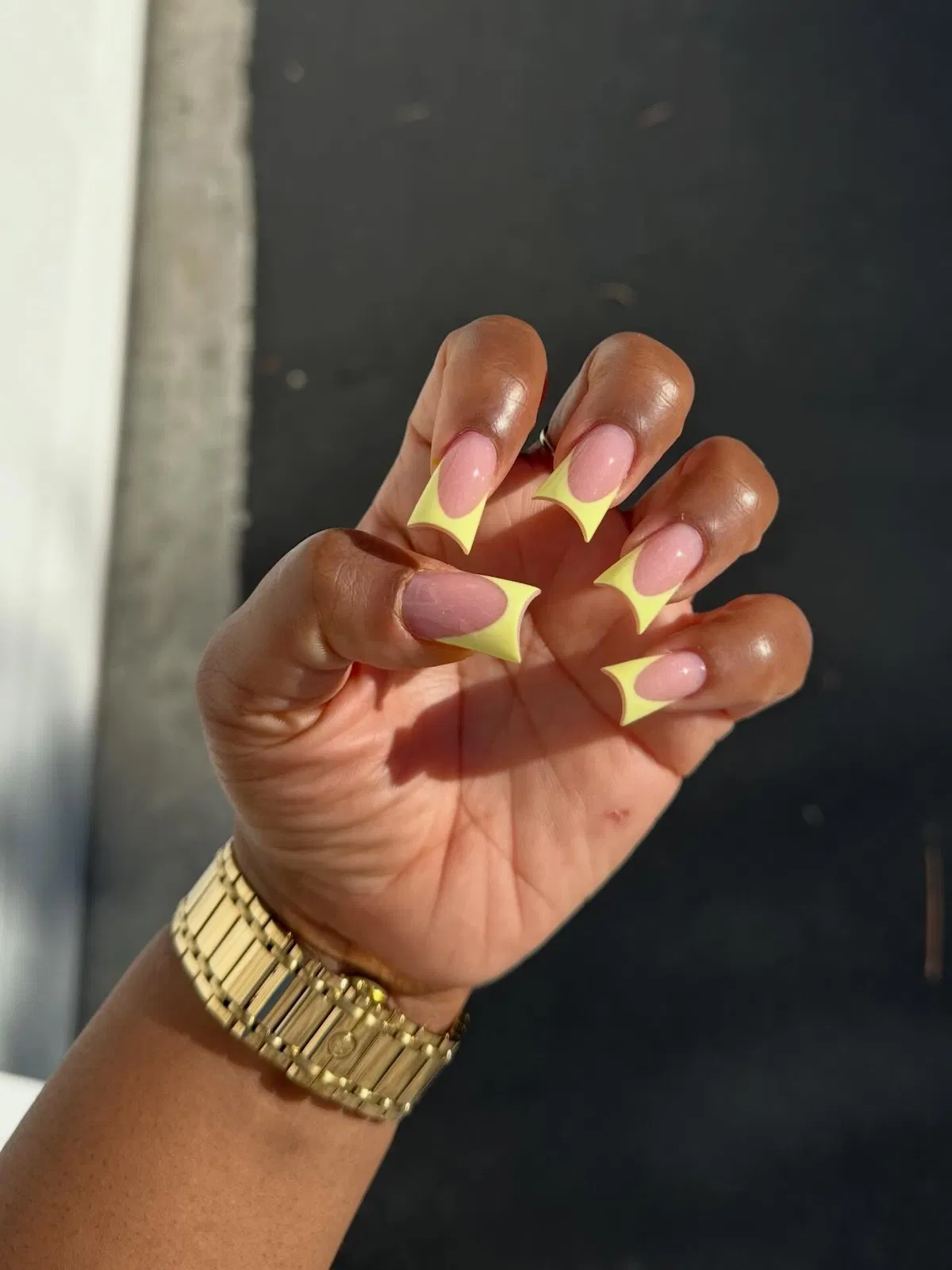 Pale yellow curved square French tips on nude base