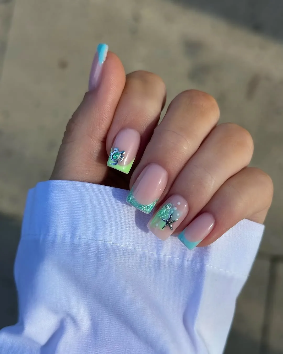 Teal French tips with turtle and starfish accents