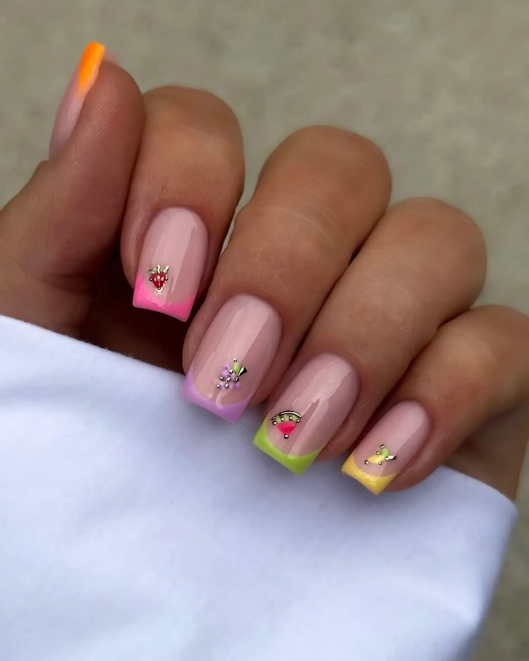 Pastel French tips with tiny fruit-style accents