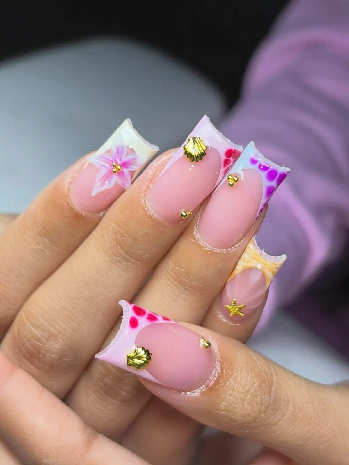 Mixed patterned French tips with gold shell and starfish charms