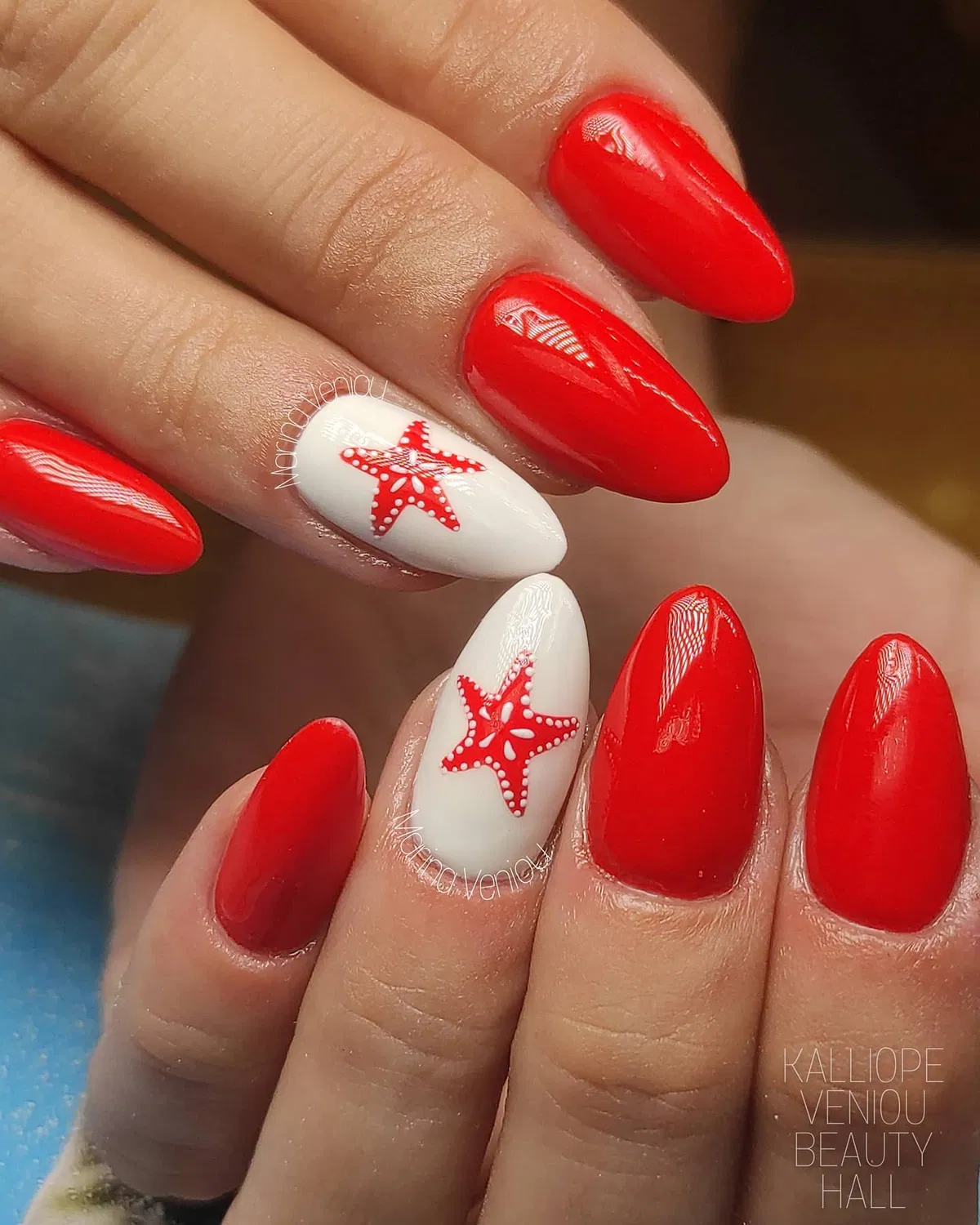 Classic glossy red with white starfish accent nails