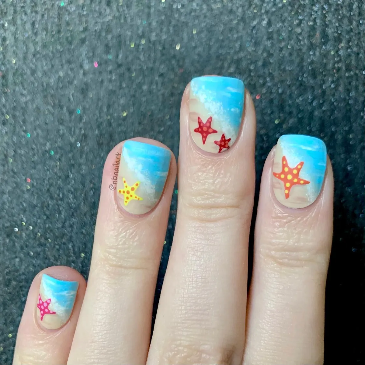 Blue gradient nails with colorful starfish