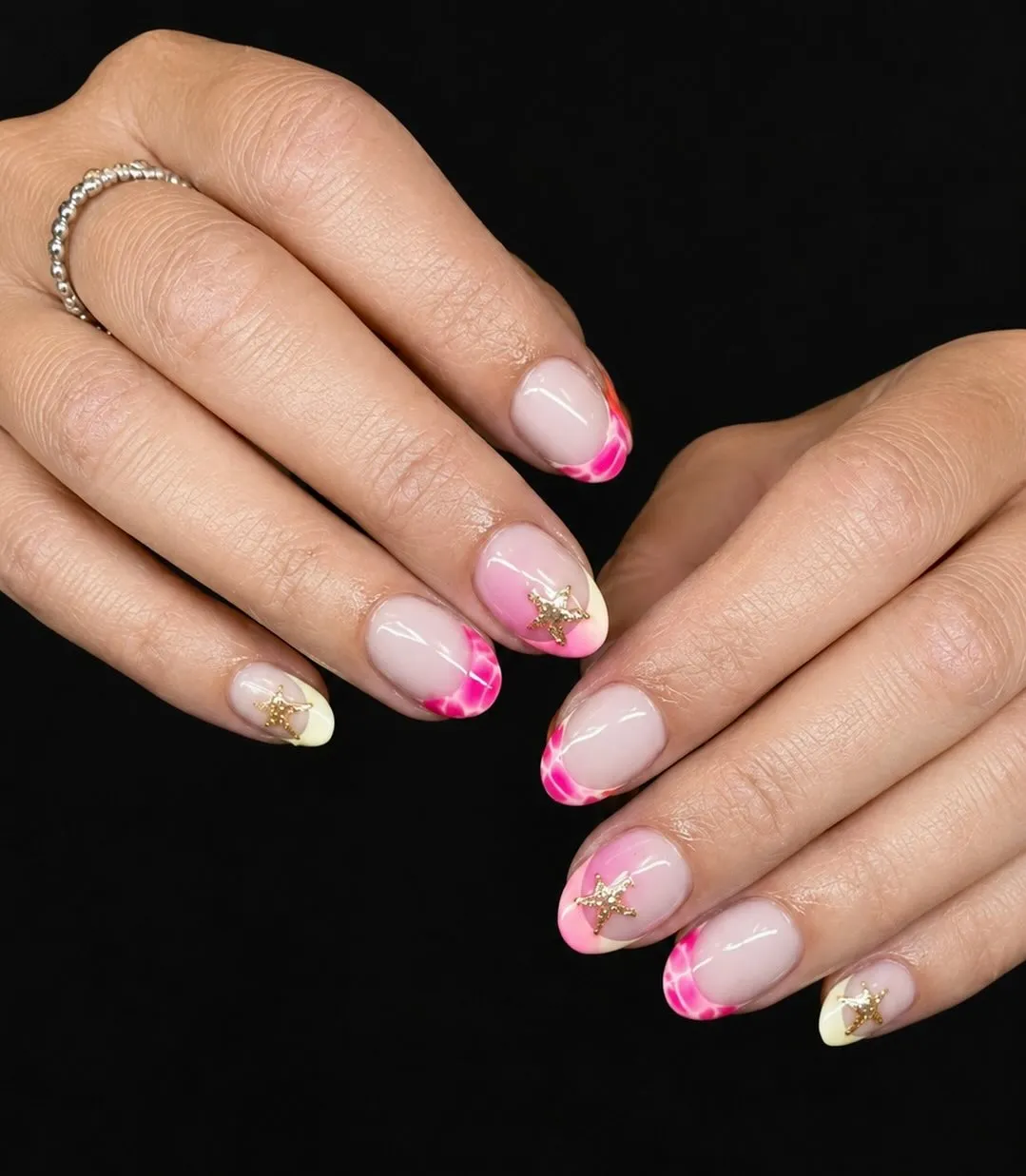 Pink marbled French tips with gold starfish charms