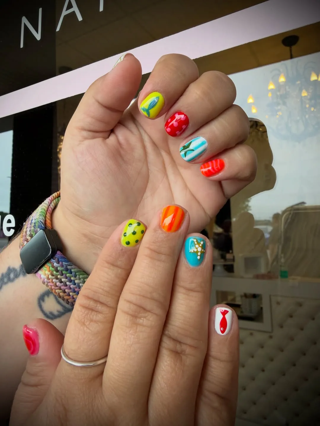 Bright mixed mani with fish, hearts, and dots
