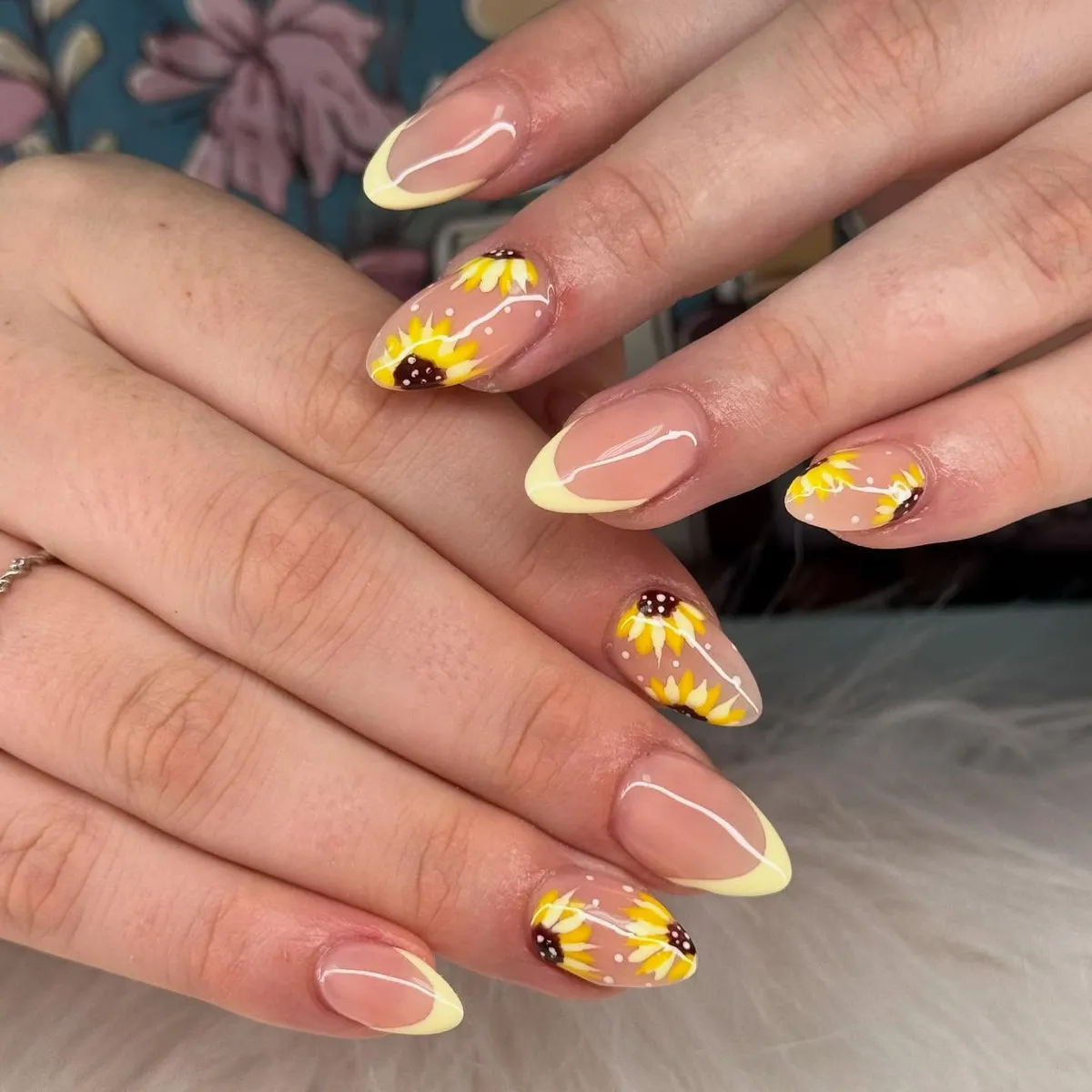 Nude French tips with sunflower accents and white linework