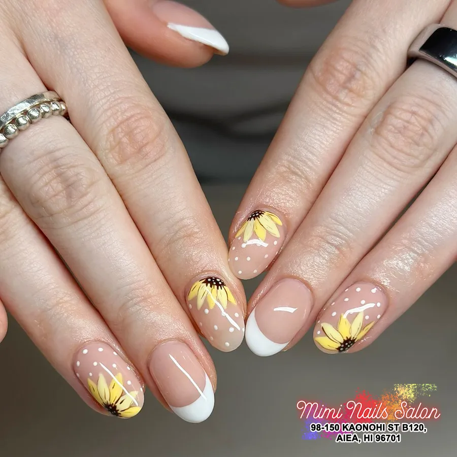 Nude-and-white French tips with yellow petals and white dot accents