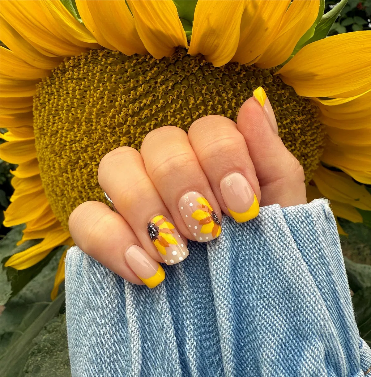 Yellow French tips with sunflower accents and white dot details