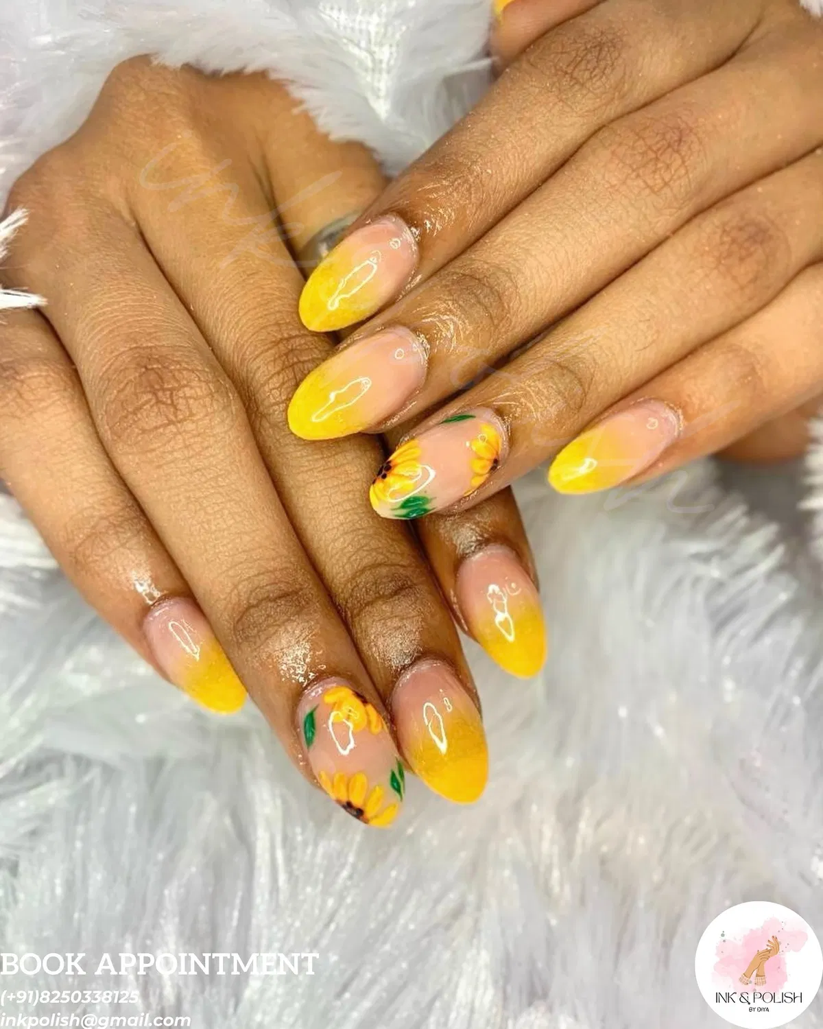 Yellow ombré almond nails with sunflower accents and salon text overlay
