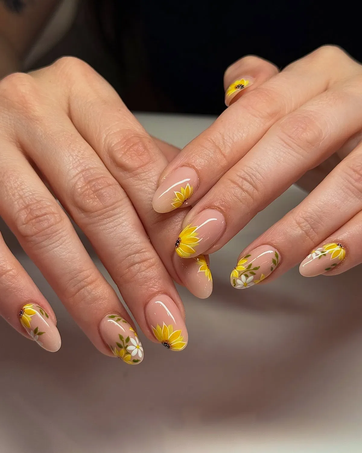 Glossy nude base with yellow flowers and green leaves