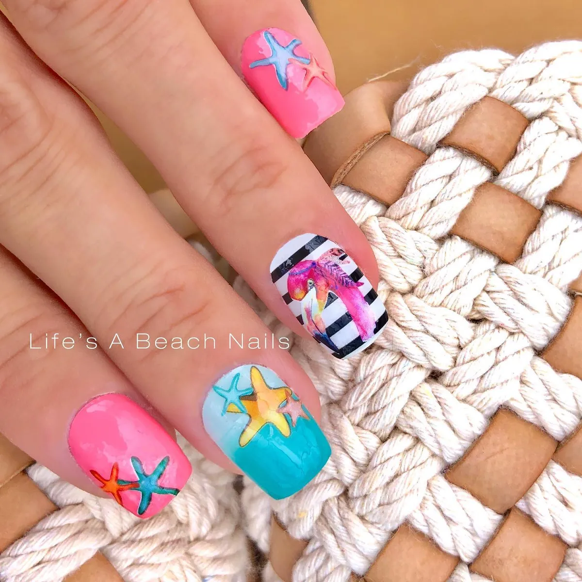 Starfish accents and striped nail with multicolor bird illustration
