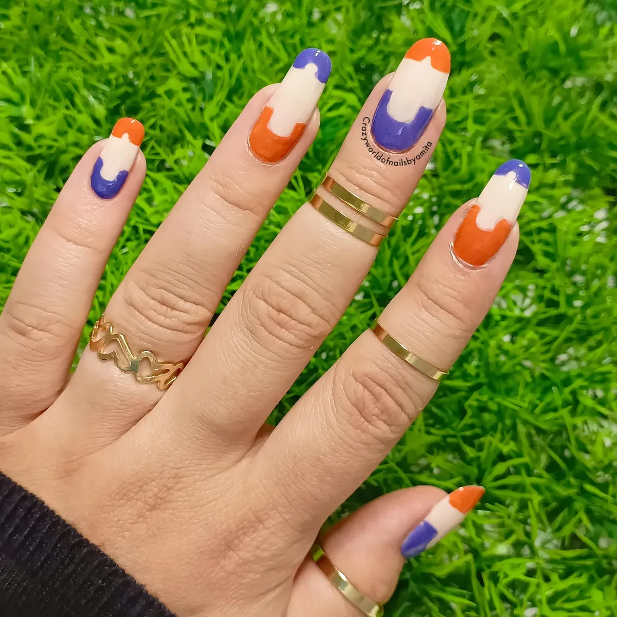 Orange, purple, and cream abstract color-block nails