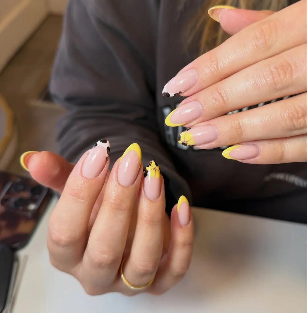 Yellow French tips with black abstract accents