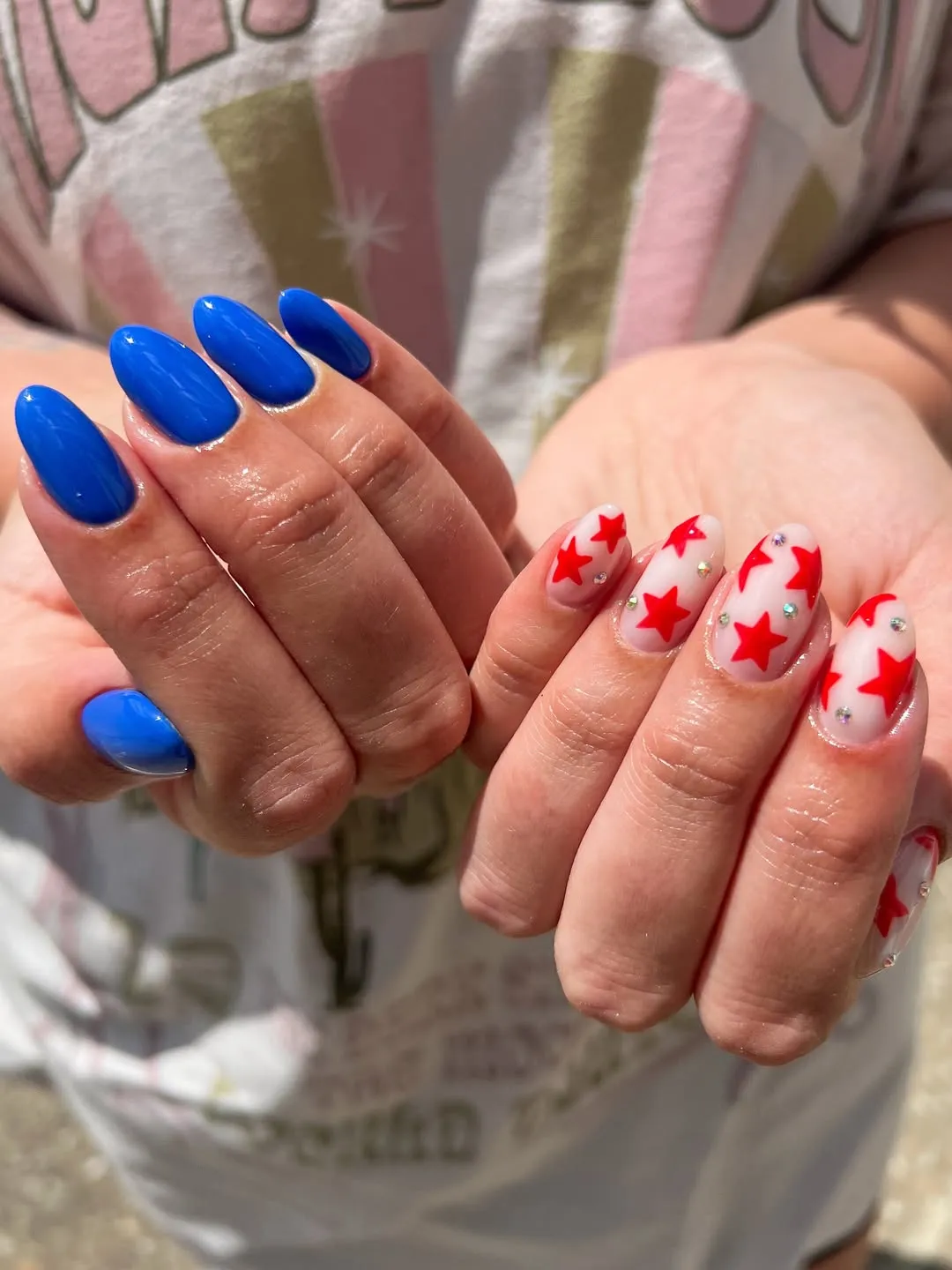 Solid blue nails paired with red star accents and small gems