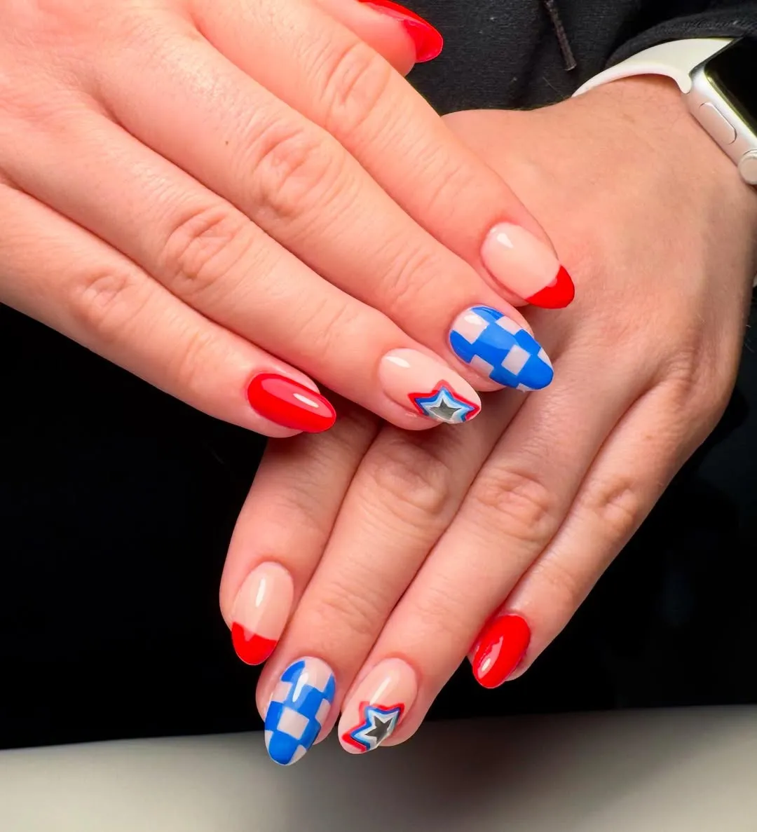 Red French tips with blue checkerboard and outlined star accents
