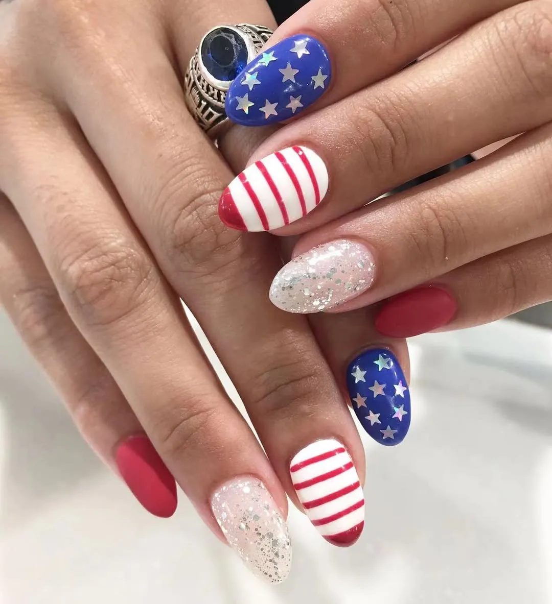 Almond set with star decals, striped accents, and glitter nails