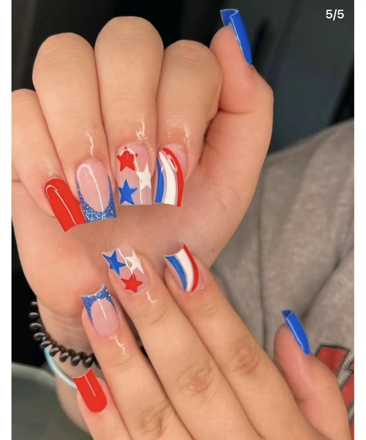 Long square set with red solids, blue glitter tips, and star graphics