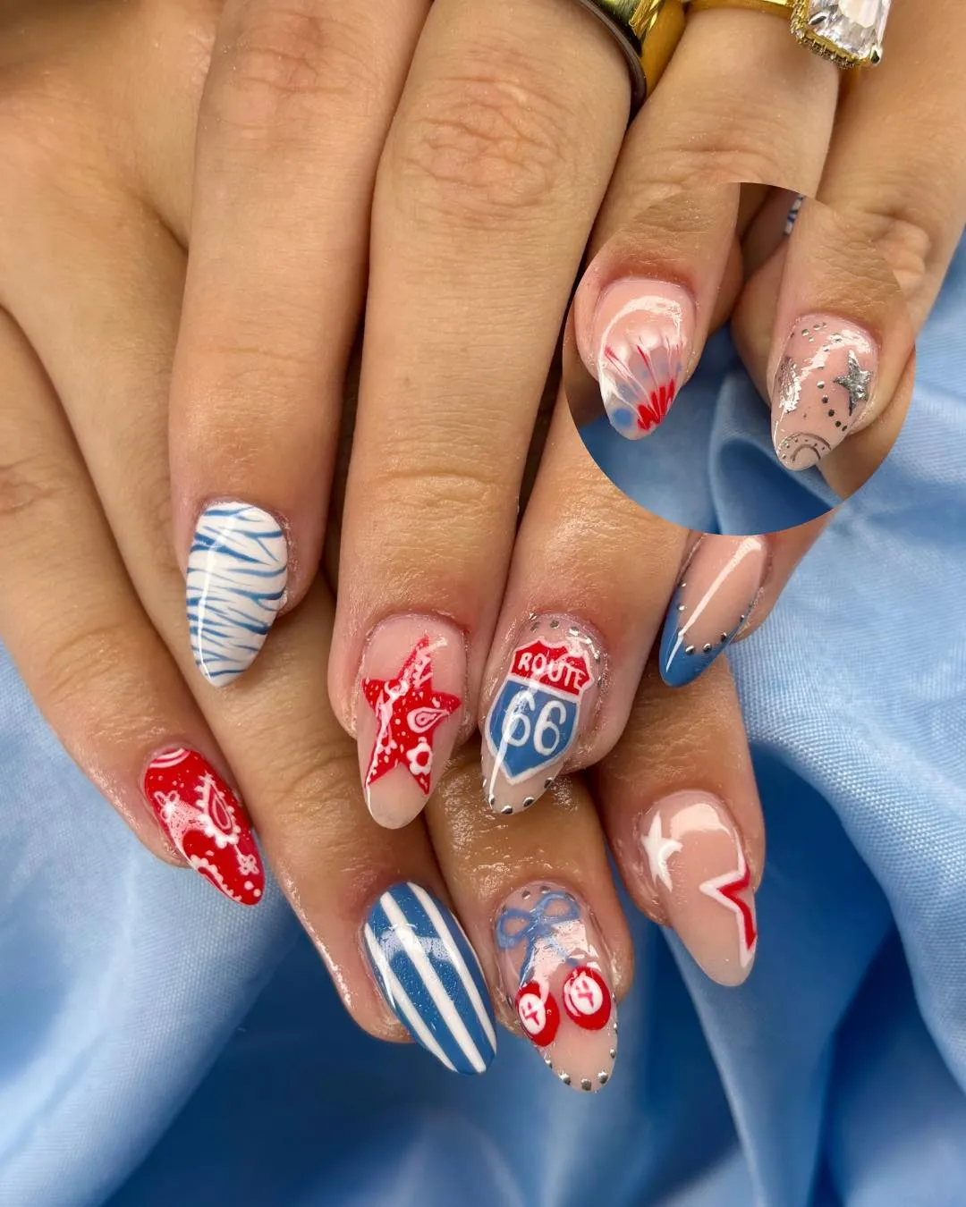 Graphic nail art with βROUTE 66β and red/blue accents