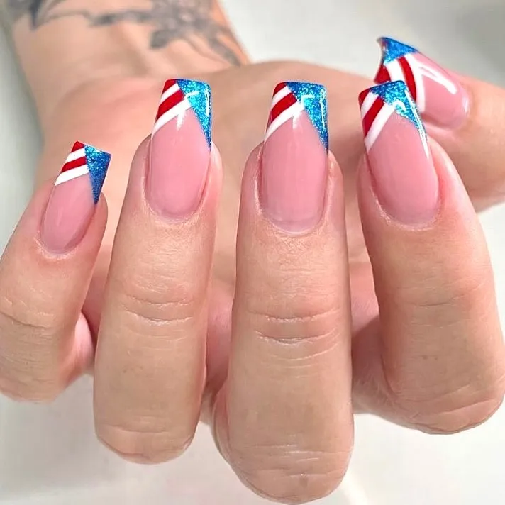 Diagonal glitter tips with red-white stripe accents