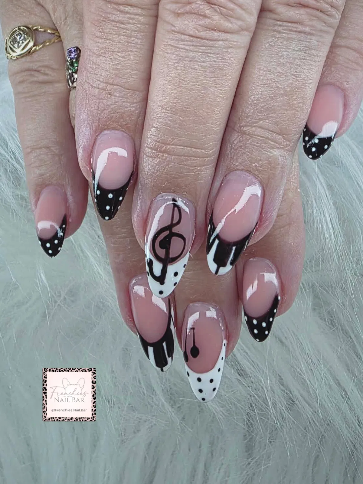 Graphic black tips with white dots and a treble clef accent