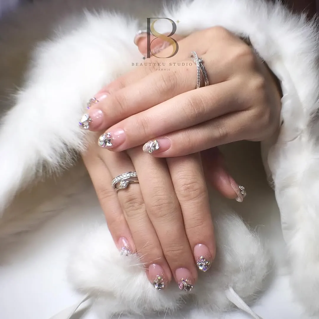 Pale pink gloss with large rhinestone clusters