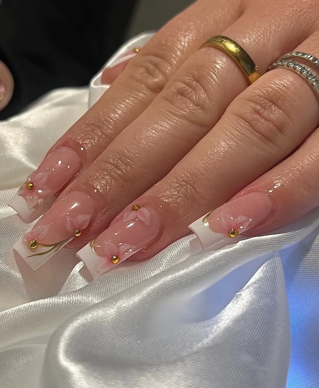 Square French tips with raised pink florals and gold studs