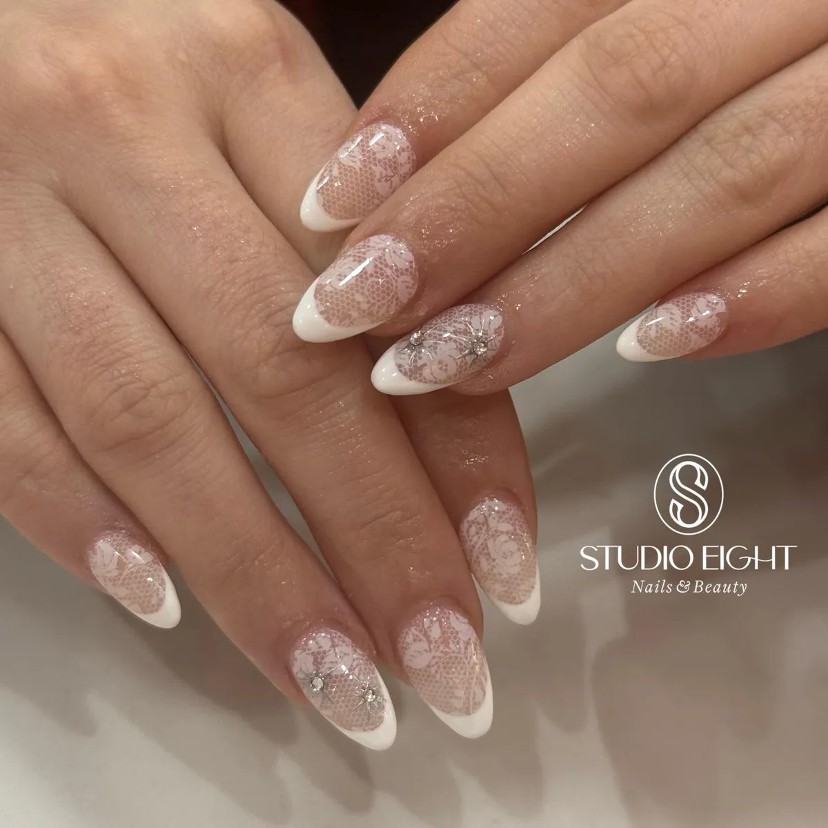 Lace-overlay French tips with rhinestones