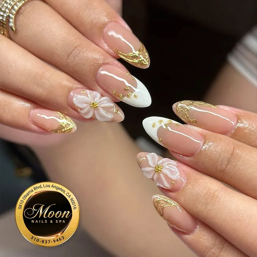 French tips with gold accents and 3D white flowers