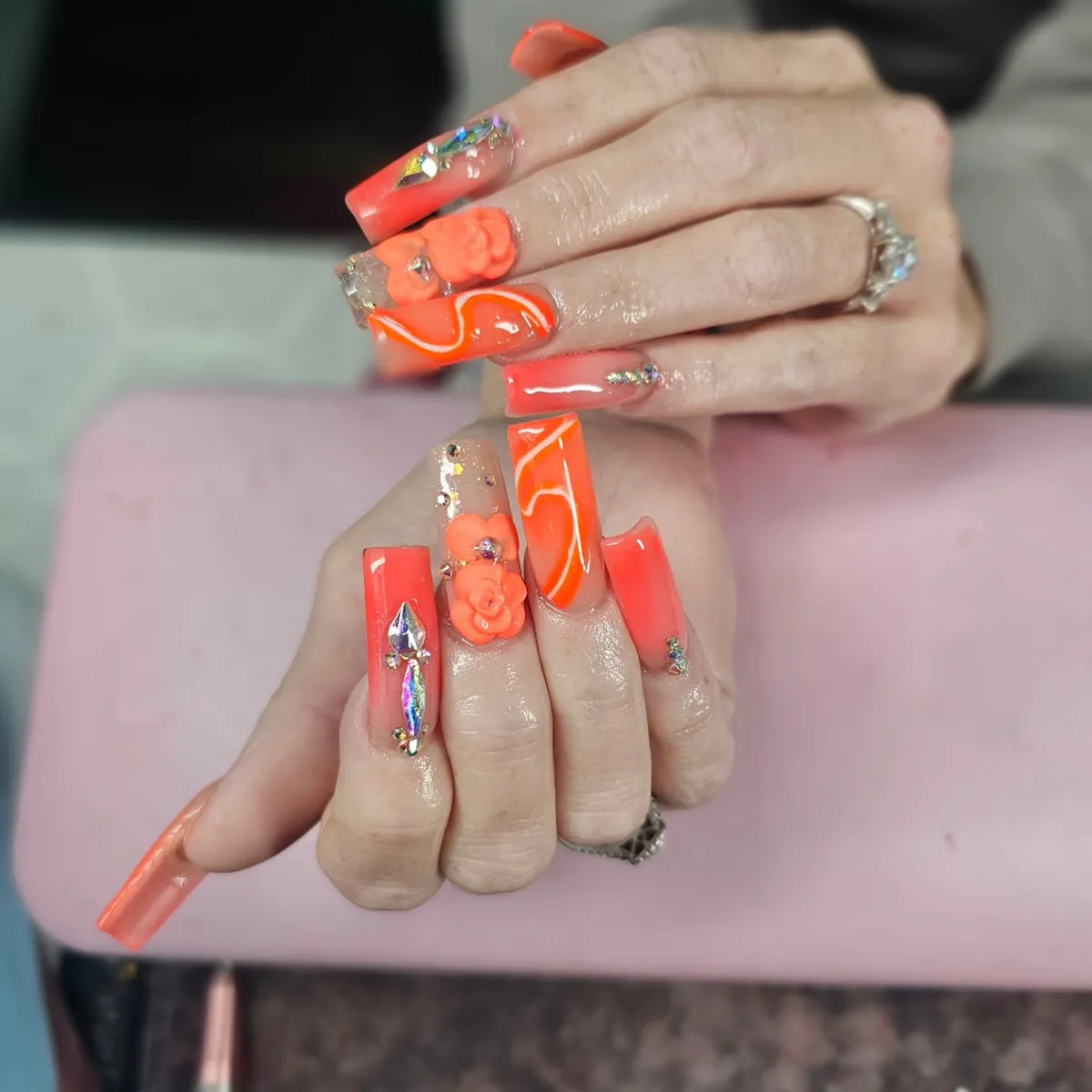 Extra-Long Orange Square Nails with Wavy Lines and 3D Florals