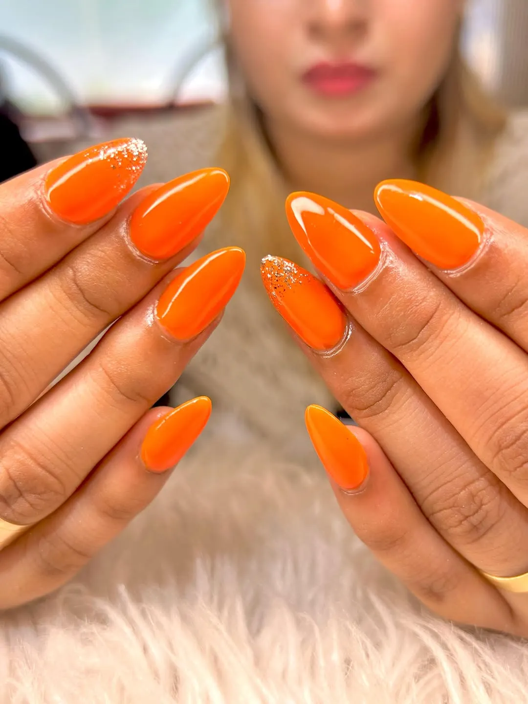 Glossy Bright Orange Almond Nails with Silver Glitter Tips