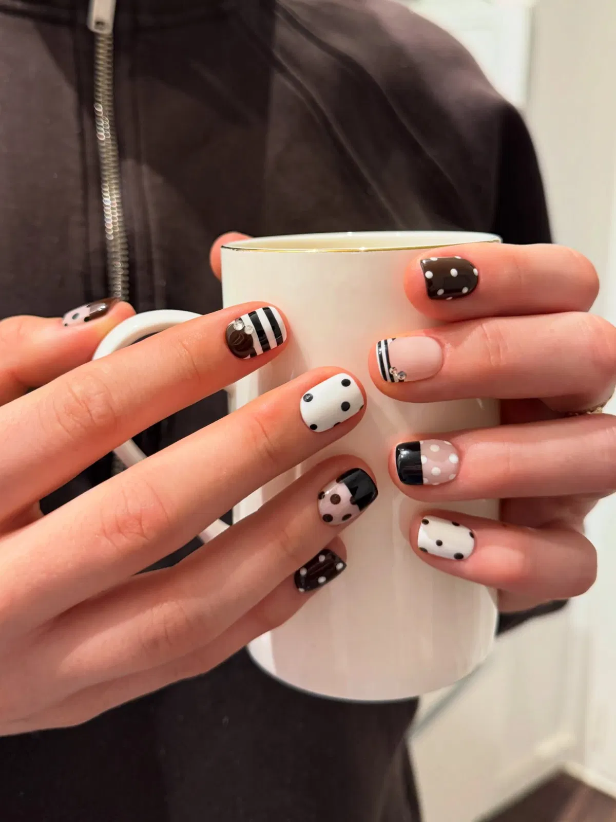 Short mixed polka dots and stripes while holding a white mug