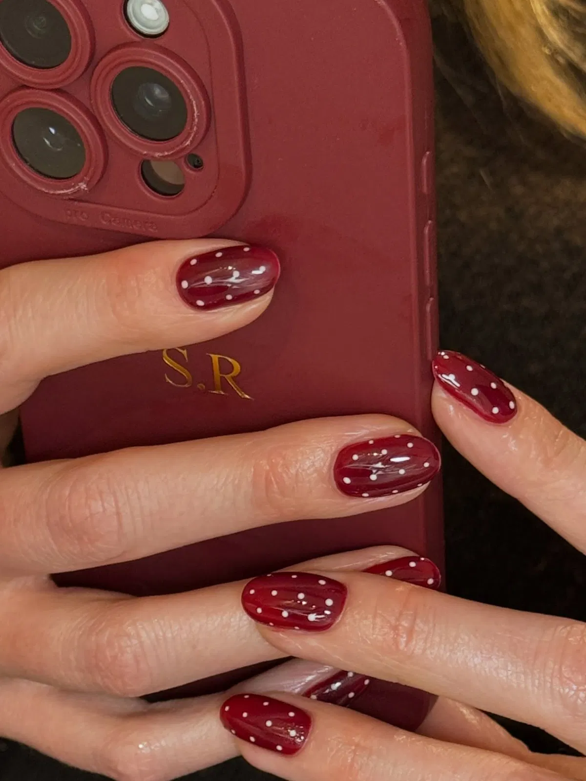 Glossy Burgundy Polka Dot Nails with Scattered White Dots