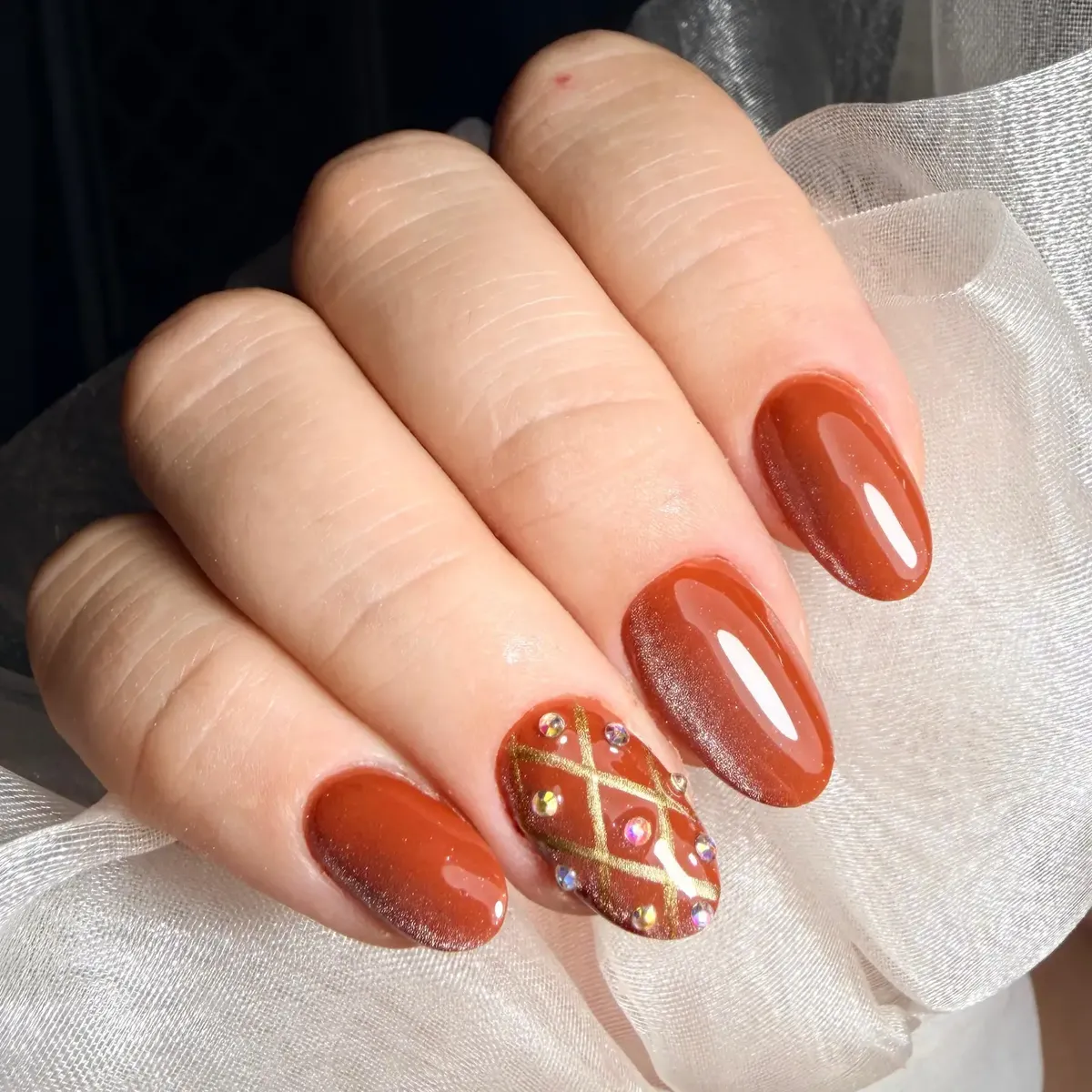 Burnt orange with gold crisscross and rhinestone accents