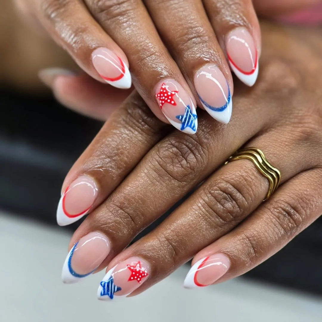 Minimal French tips with red/blue outline arcs and star accents