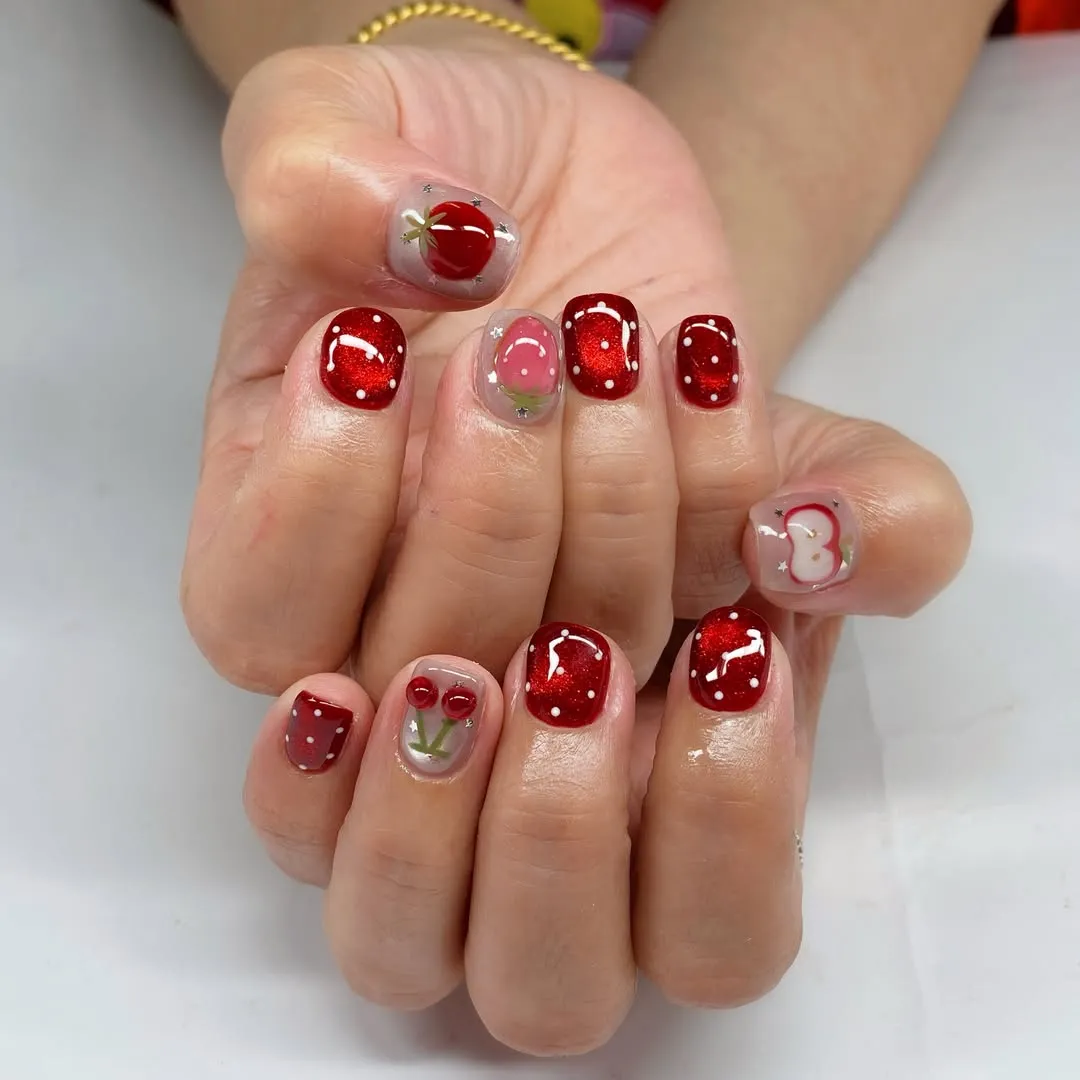 Deep red polka dots with clear accent nails
