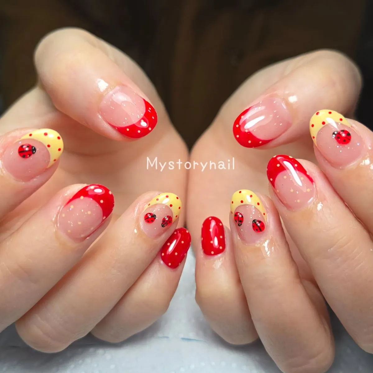 Red polka-dot French tips with ladybug accents