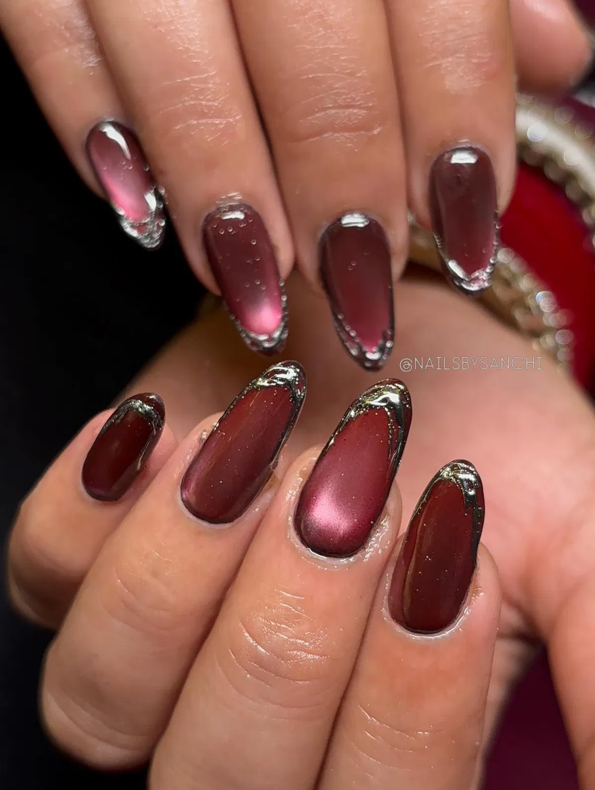 Burgundy Nails with Silver-Edged Outlines and Reflective Centers