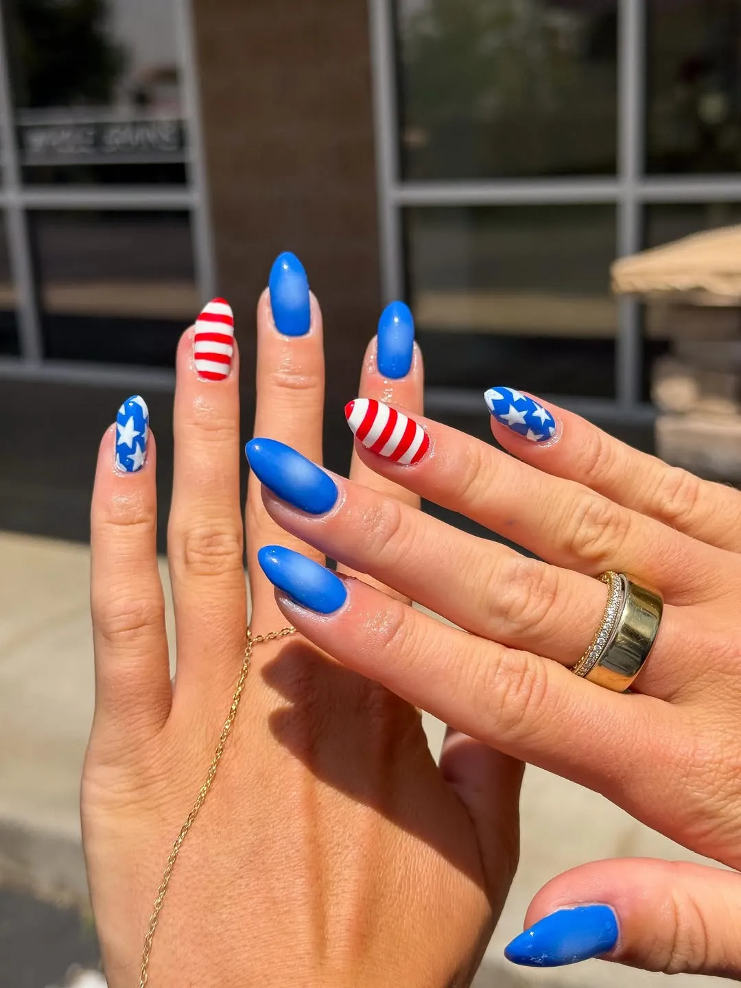 Bright blue solids with striped and star accent nails