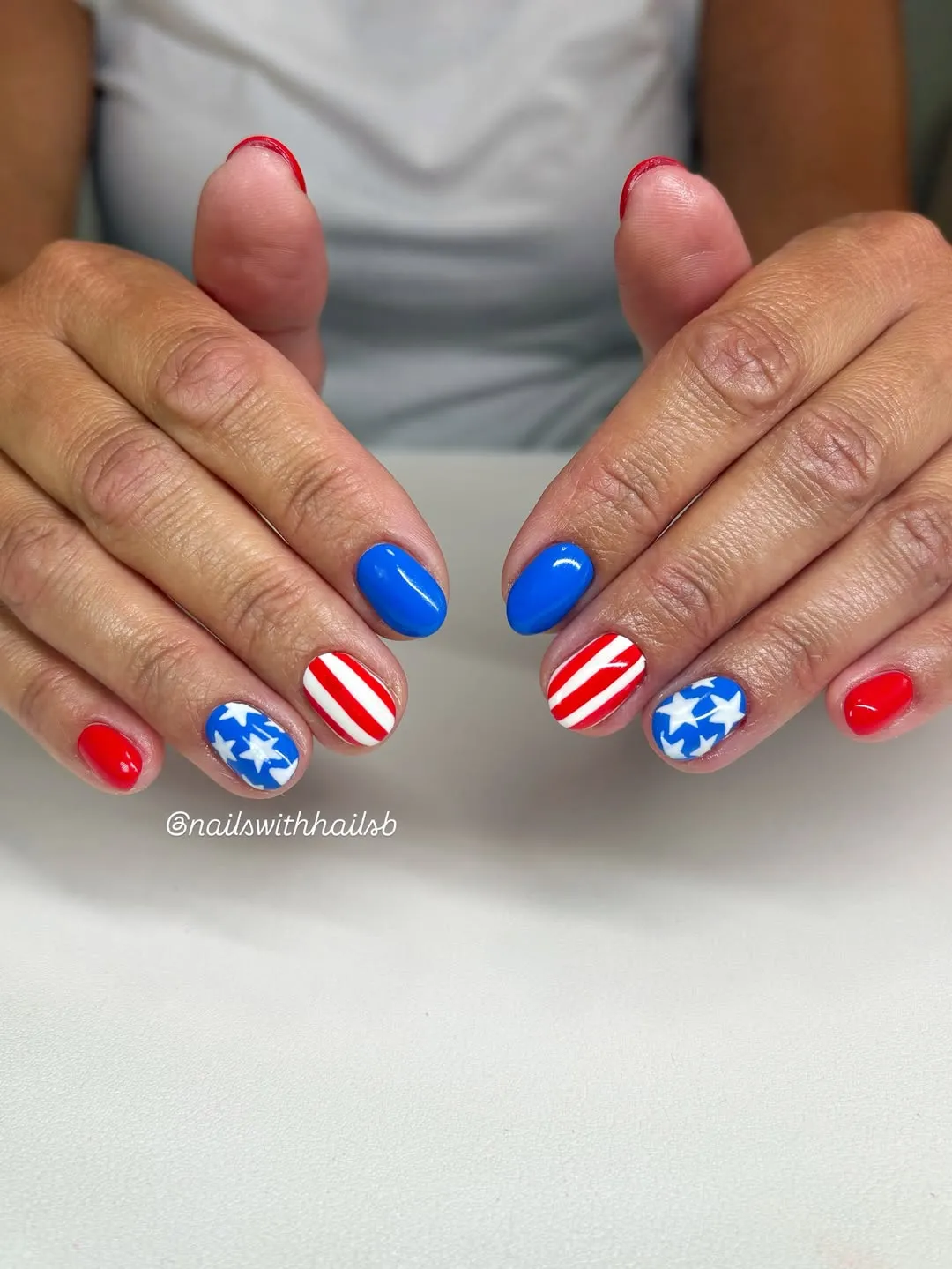 Simple red/blue solids with striped and star accent nails