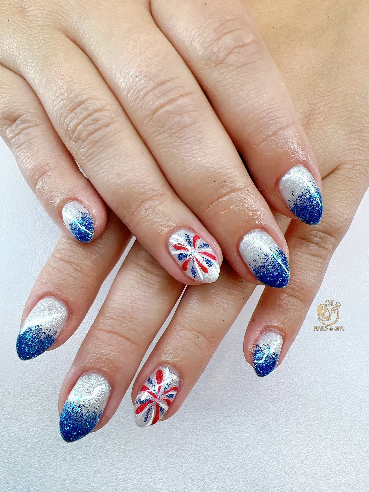 Silver shimmer with blue glitter tips and pinwheel bursts