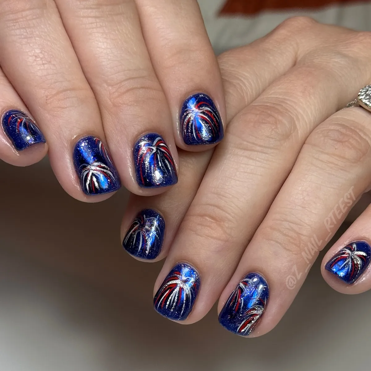 Midnight-blue sparkly base with curved firework bursts