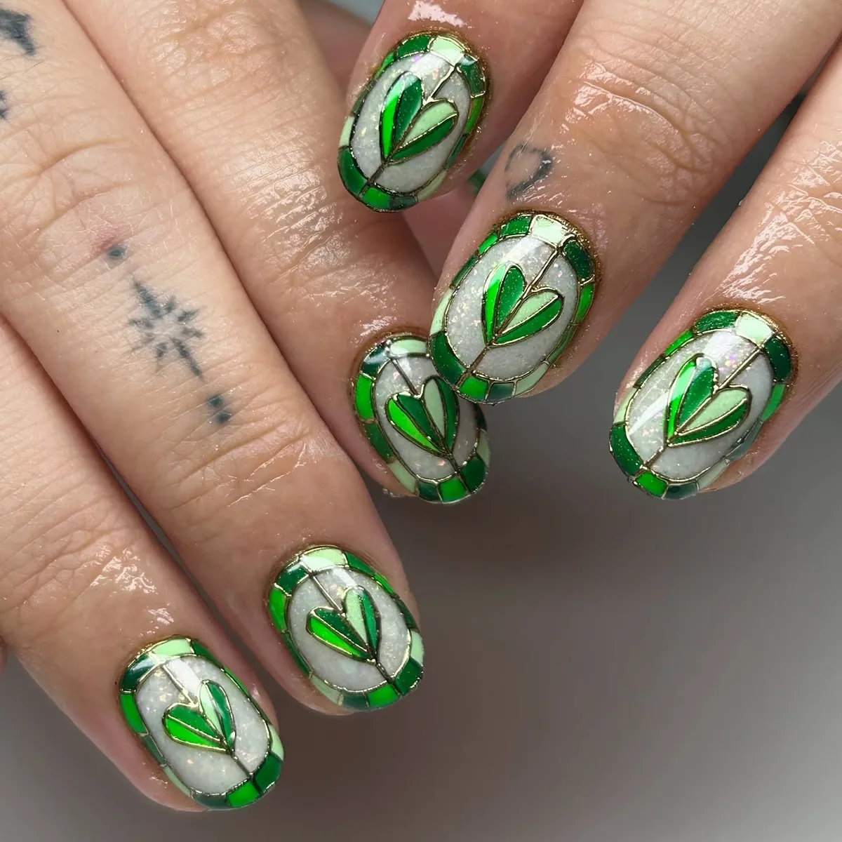 Green stained-glass pattern with gold outlines