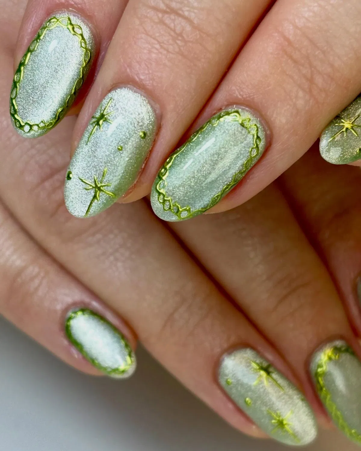 Silvery green shimmer with starbursts and scalloped edging