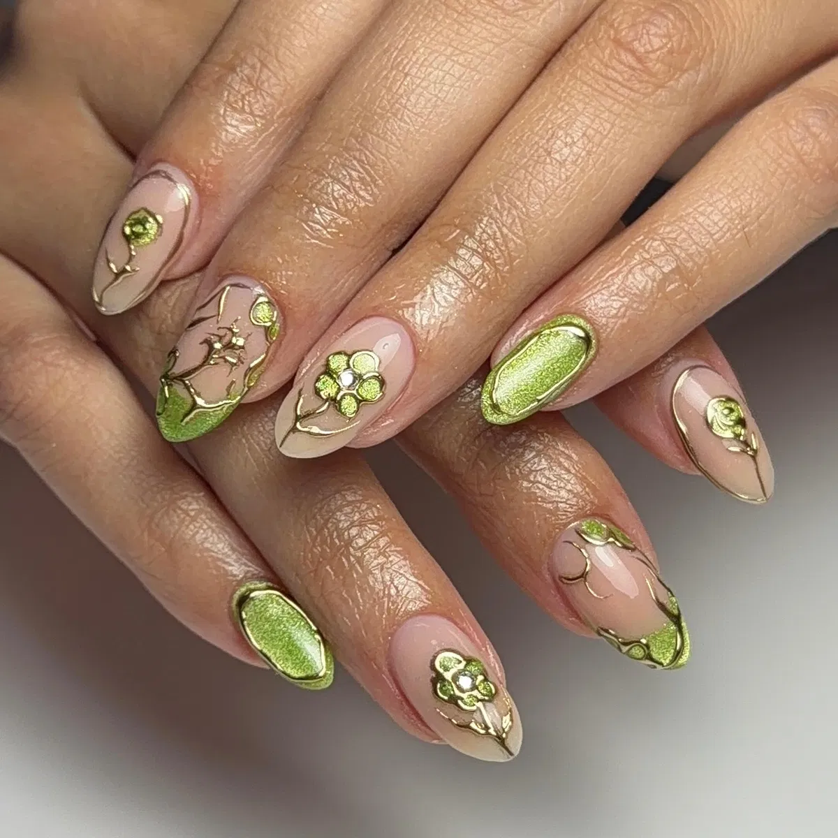 Nude florals with metallic gold outlines and green accents