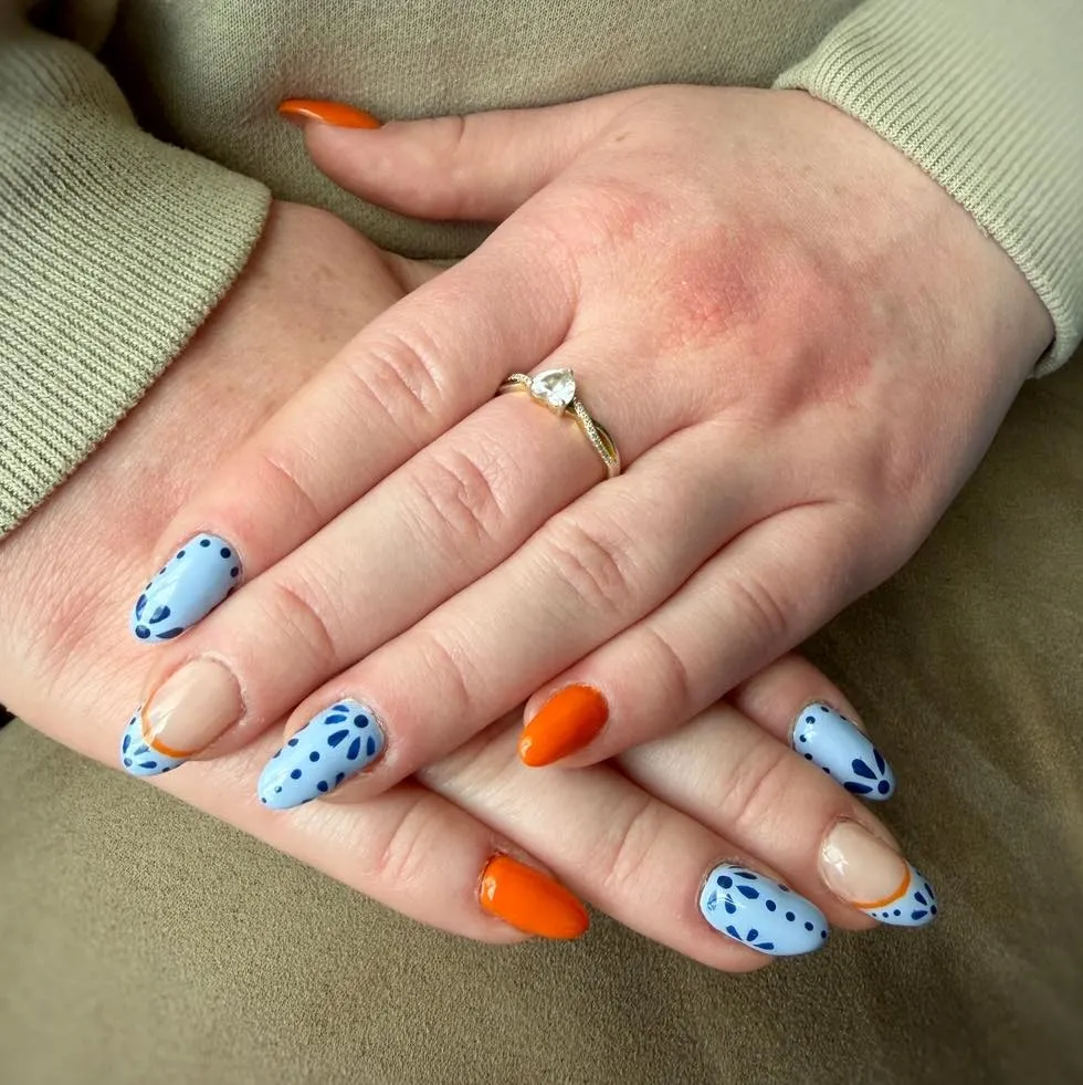 Light blue dotted florals with orange accent nails