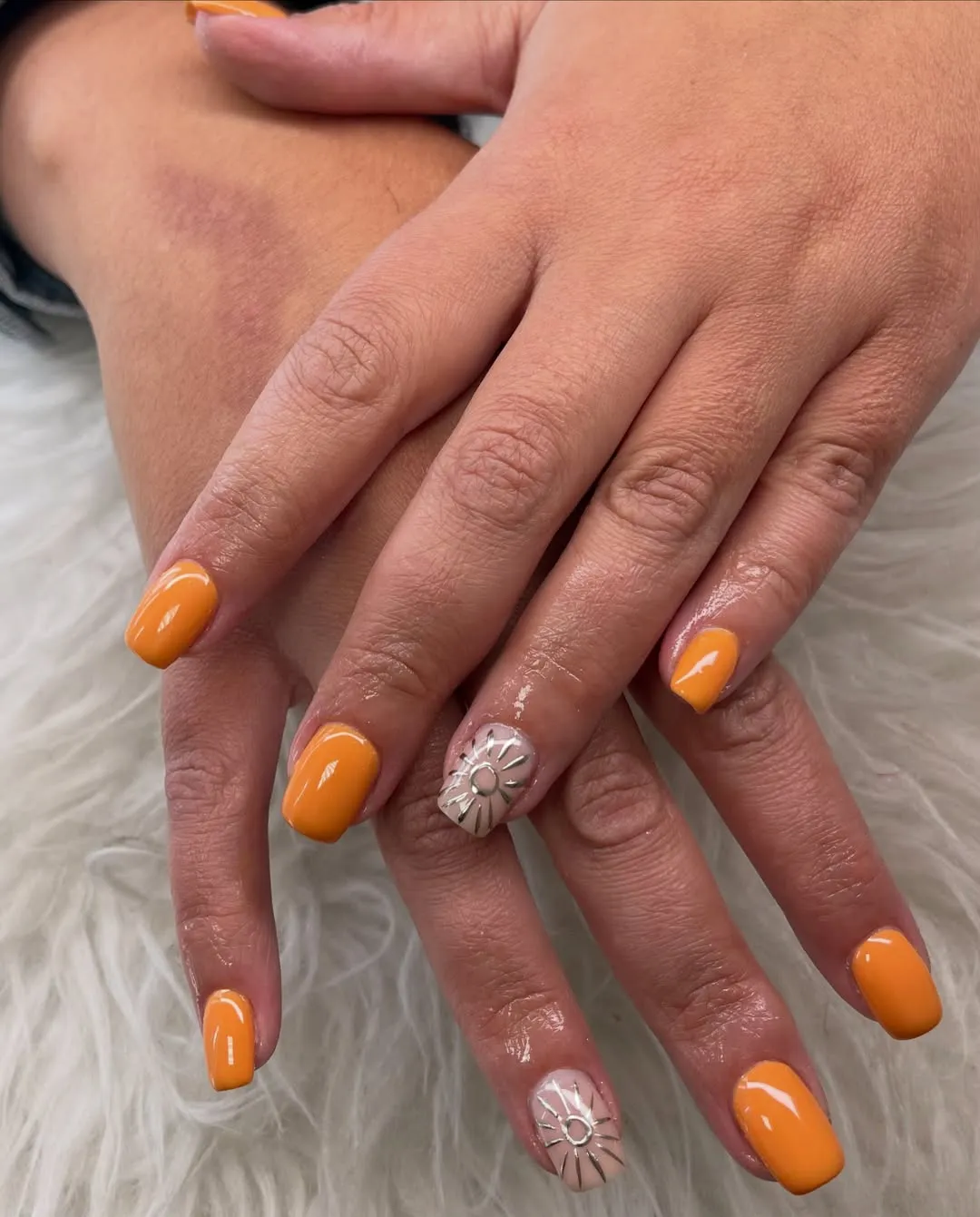 Solid orange nails with sunburst accent nails