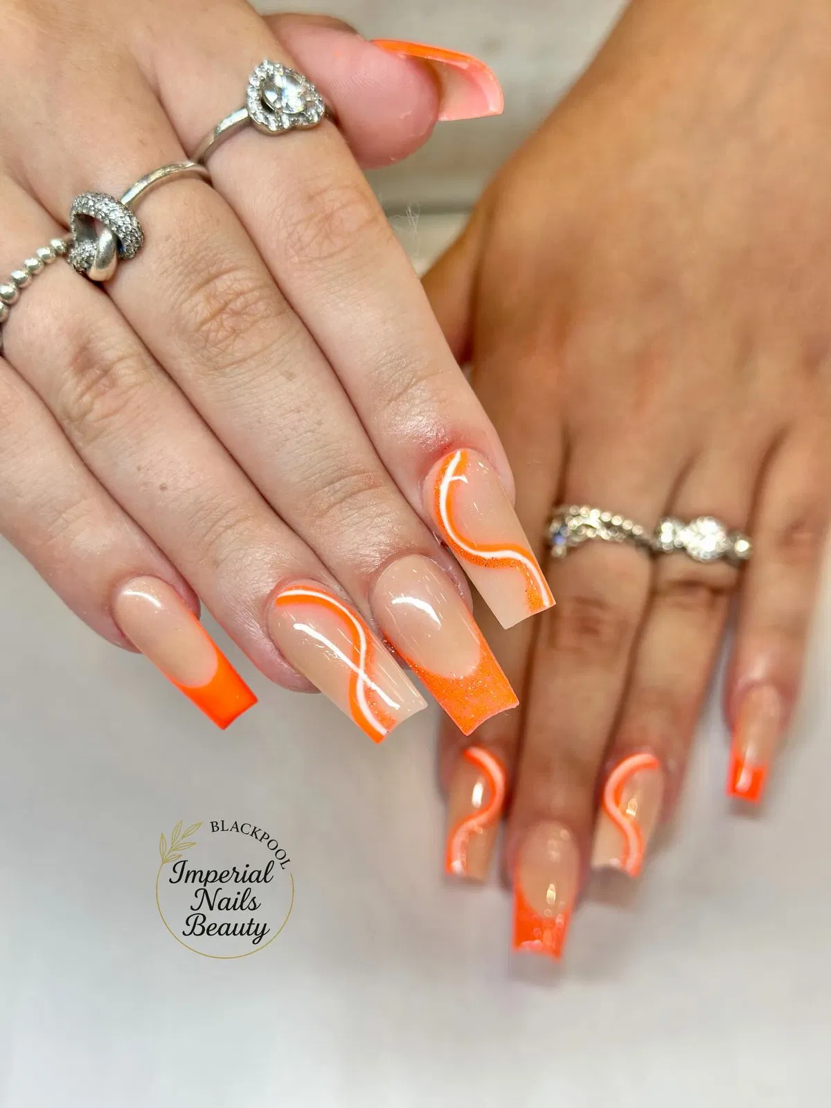 Bright Orange French Tips with White Wave Lines