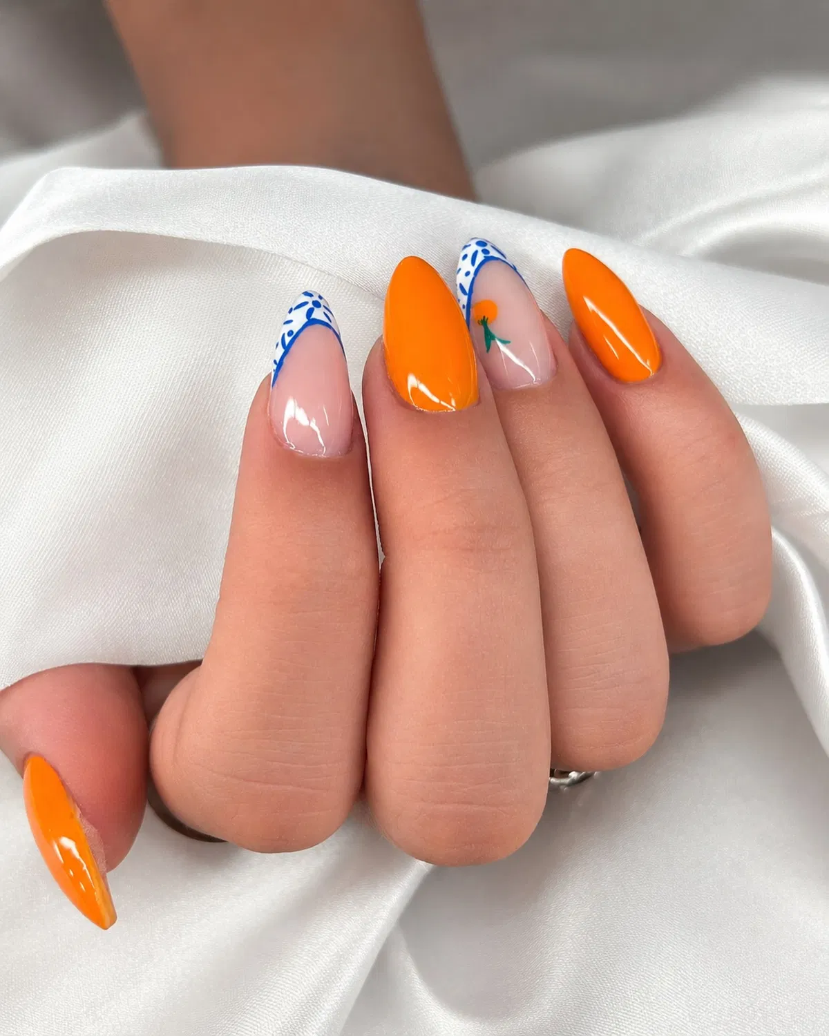 Bright orange solids with blue patterned French tips