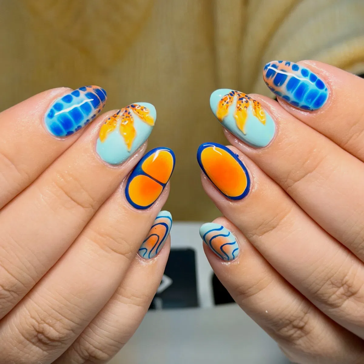 Aqua base with orange gradients, blue outlines, and mixed pattern accents