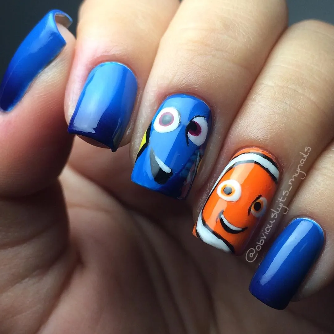 Blue-and-orange character nail art with solid blue nails