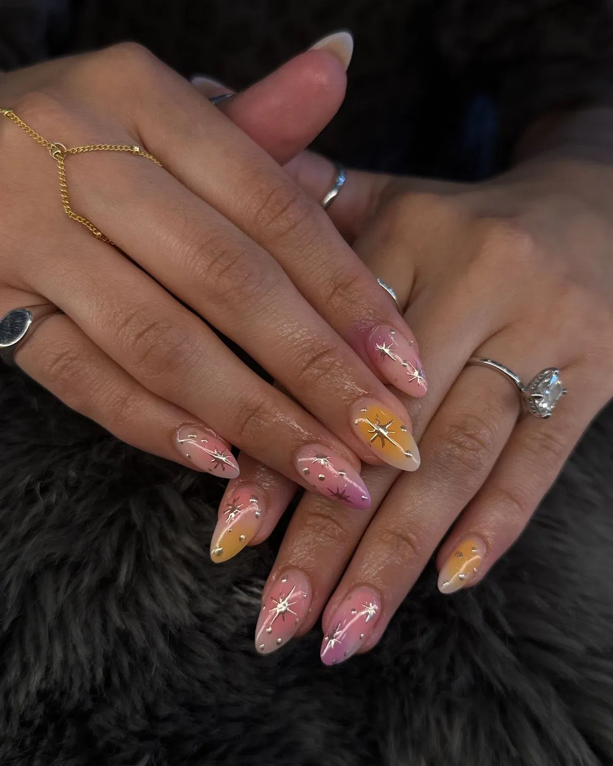 Pink-to-orange gradients with silver starbursts and gems